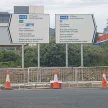 Two ROADWAY signs pointing to northbound and southbound motorways